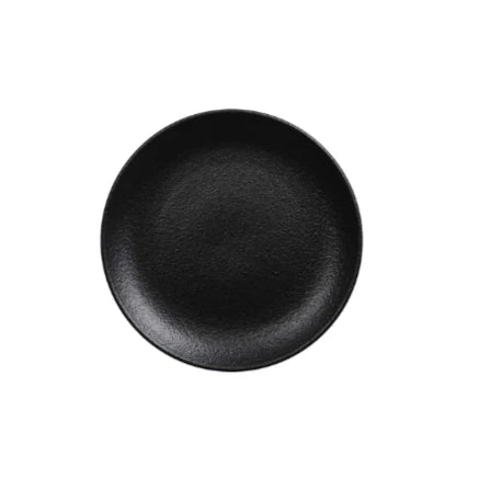 Empty round black porcelain coupe plate viewed from above