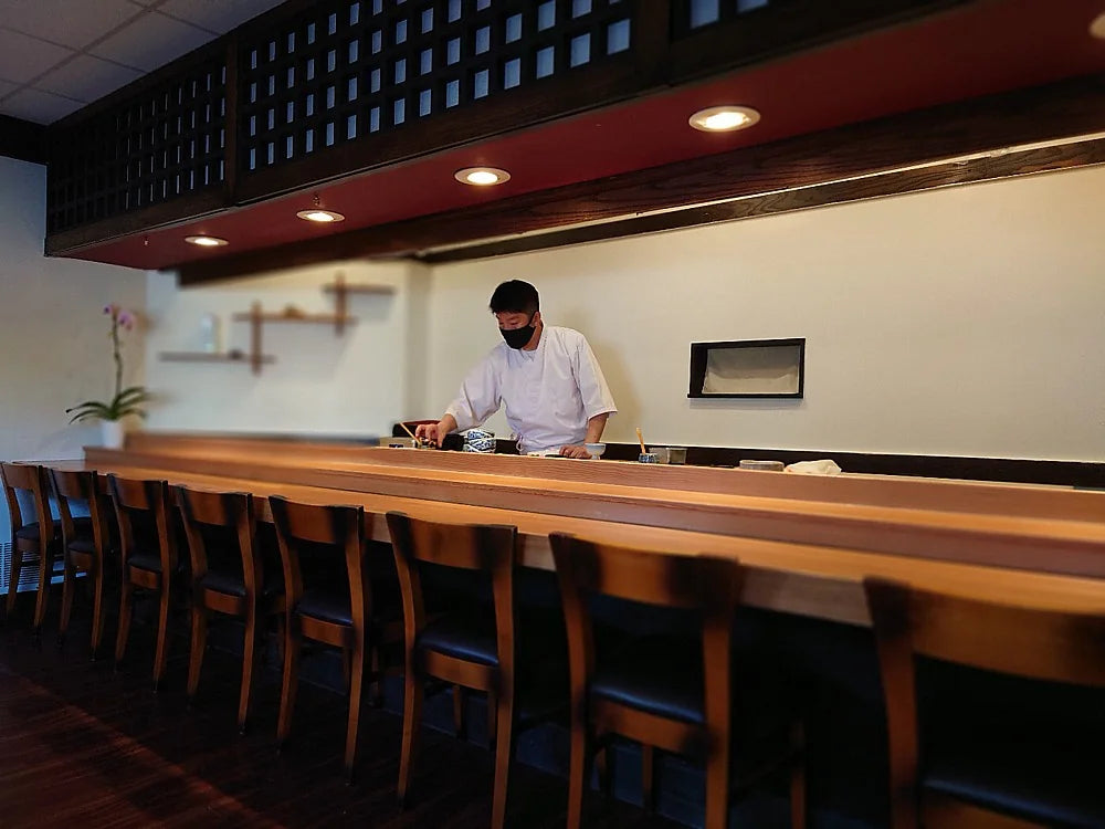 Chef and place settings at the Sushi Takeda counter in Little Tokyo, Los Angeles
