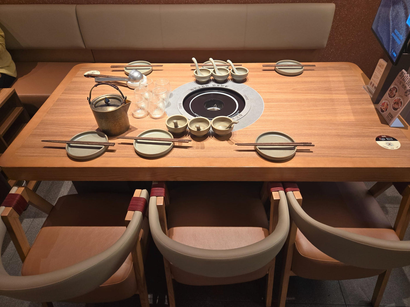 Hot-pot table with built-in cooking position and compact individual bowls