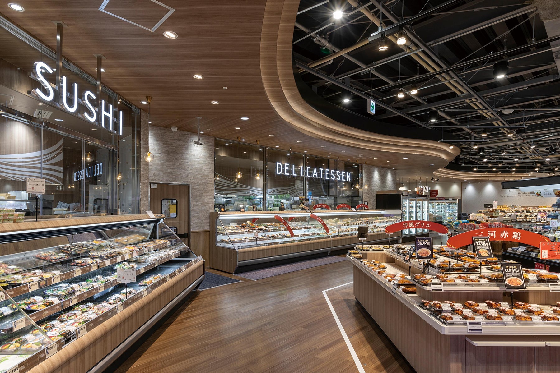 Supermarket sushi department with refrigerated prepared-food displays and an open service counter.